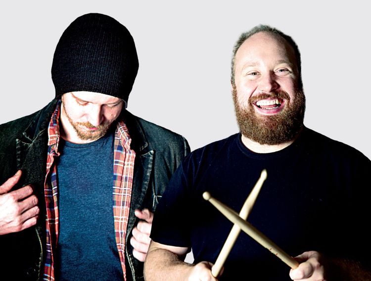 Jonny Donahoe holds drumsticks while Paddy Gervers looks down